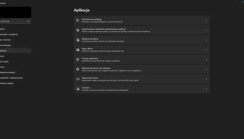 Ekran ustawień Windows z menu po lewej i sekcją "Aplikacje" po prawej.
